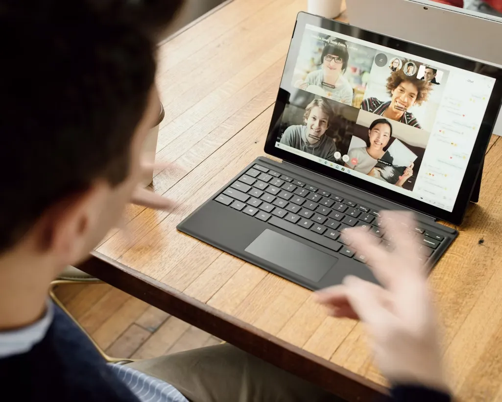 Professional video conference meeting on laptop with remote team.