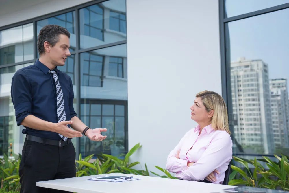 Business people discussing outdoors with city buildings background.