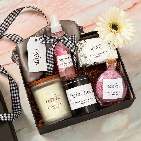 Spa gift basket with rose water, facial steam, candle, and bath soak products.